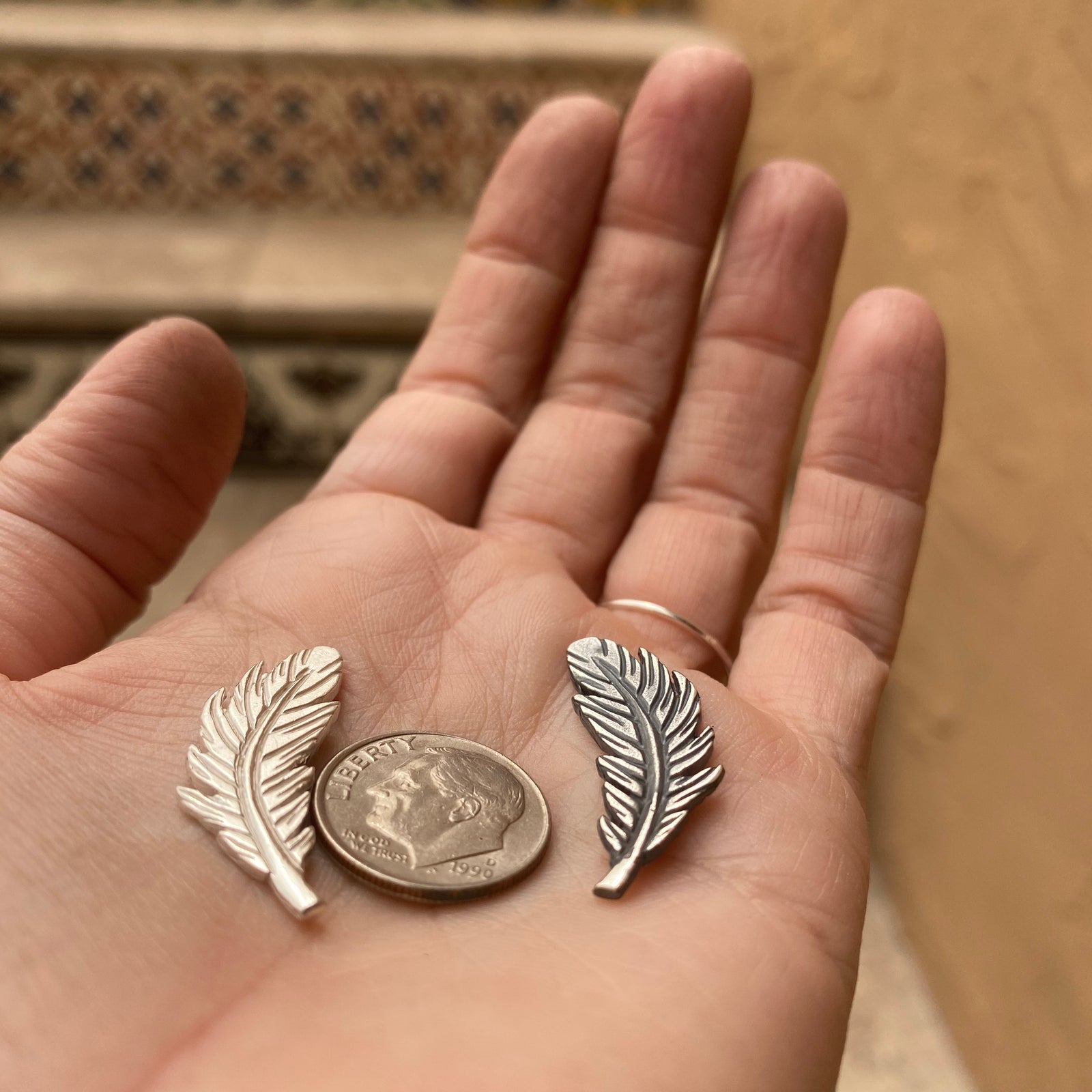 sterling silver feather casting with dime for size reference