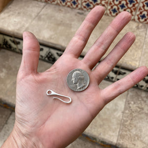 silver cast hook clasp with quarter for size reference
